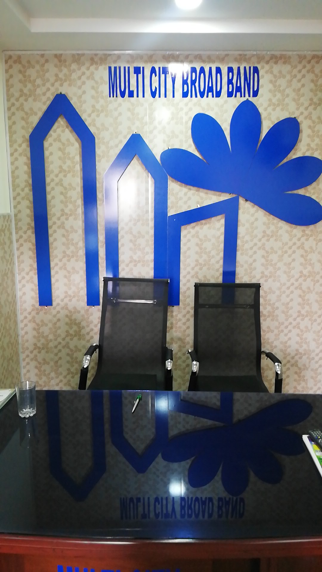 Reception seating and Multicity Broadband wall identity inside the Attock office.